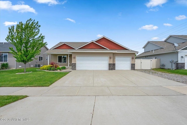 6463 W Conner St, Rathdrum, ID 83858 - craftsman-style home featuring stone siding, an attached garage, driveway, and a gate