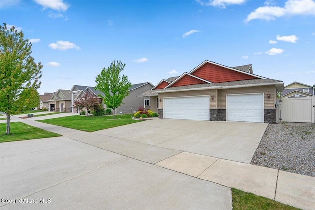 6463 W Conner St, Rathdrum, ID 83858 - craftsman inspired home with stone siding, a garage, concrete driveway, and a gate