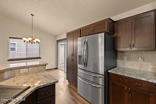 6463 W Conner St, Rathdrum, ID 83858 - kitchen with stainless steel refrigerator with ice dispenser, lofted ceiling, a chandelier, wood finished floors, and dark brown cabinetry