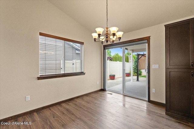 6463 W Conner St, Rathdrum, ID 83858 - empty room featuring a chandelier, wood finished floors, and lofted ceiling