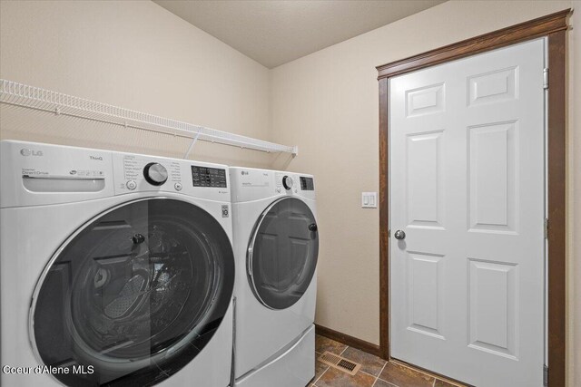 6463 W Conner St, Rathdrum, ID 83858 - laundry room with washer and clothes dryer and baseboards