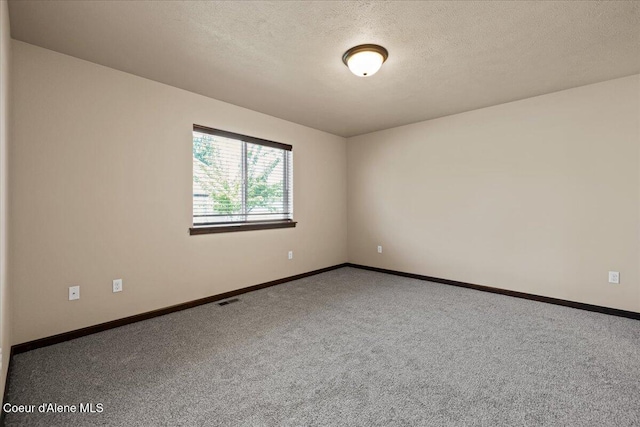 6463 W Conner St, Rathdrum, ID 83858 - carpeted spare room with baseboards and a textured ceiling