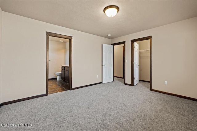 6463 W Conner St, Rathdrum, ID 83858 - unfurnished bedroom with carpet flooring, ensuite bath, a closet, a spacious closet, and a textured ceiling