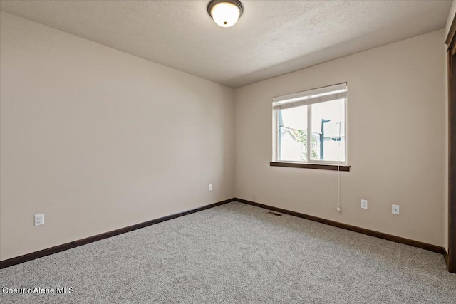 6463 W Conner St, Rathdrum, ID 83858 - empty room with carpet floors and a textured ceiling