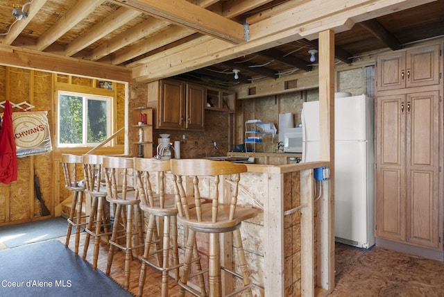 36799 W Coeur D Alene Lake Shr, Coeur Dalene, ID 83814 - kitchen with freestanding refrigerator, a kitchen breakfast bar, and a peninsula