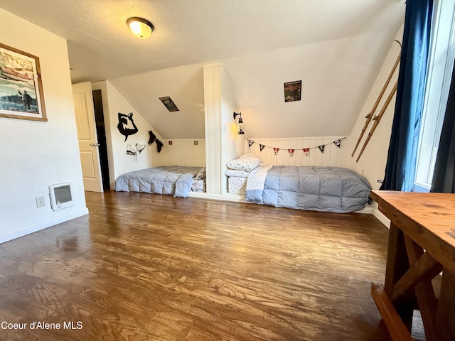 408 Quartz Crk Rd, Priest River, ID 83856 - bedroom featuring lofted ceiling, heating unit, wood finished floors, and baseboards