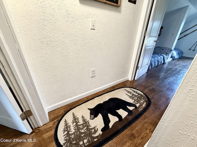 408 Quartz Crk Rd, Priest River, ID 83856 - detailed view of wood finished floors, a textured wall, and baseboards