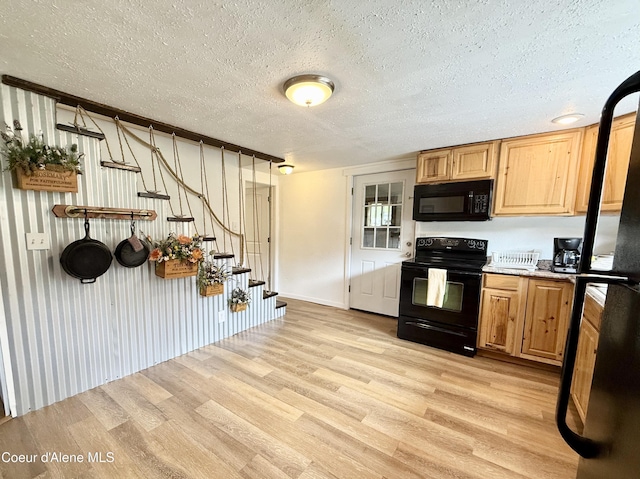 408 Quartz Crk Rd, Priest River, ID 83856 - kitchen featuring black appliances, light wood-style flooring, a textured ceiling, and baseboards