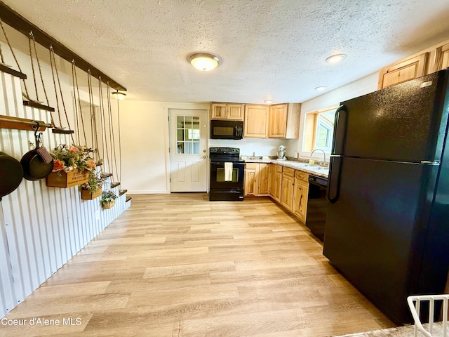 408 Quartz Crk Rd, Priest River, ID 83856 - kitchen featuring black appliances, light wood finished floors, light countertops, a textured ceiling, and light brown cabinets