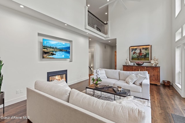 2946 E Point Hayden Dr, Hayden Lake, ID 83835 - living area with a high ceiling, a glass covered fireplace, baseboards, dark wood-style flooring, and recessed lighting