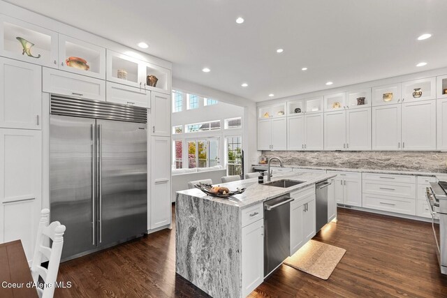 2946 E Point Hayden Dr, Hayden Lake, ID 83835 - kitchen featuring appliances with stainless steel finishes, a sink, white cabinets, backsplash, and a center island with sink