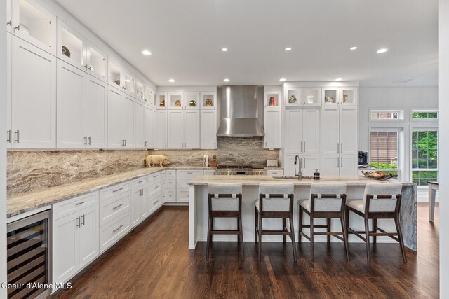 2946 E Point Hayden Dr, Hayden Lake, ID 83835 - kitchen featuring wall chimney range hood, beverage cooler, recessed lighting, a sink, and dark wood finished floors