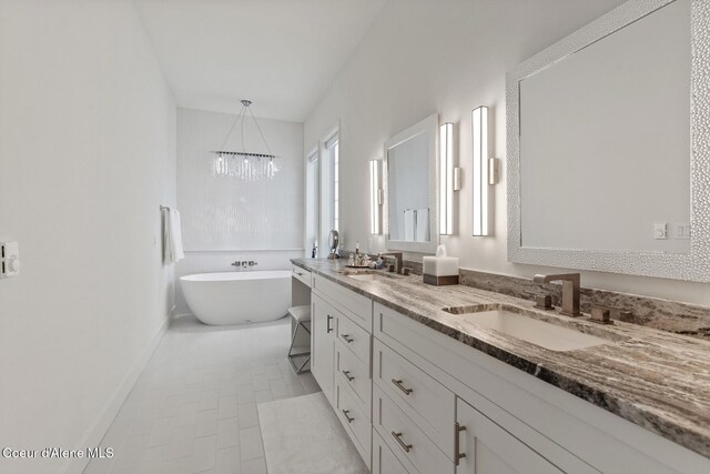 2946 E Point Hayden Dr, Hayden Lake, ID 83835 - full bath featuring double vanity, a soaking tub, a chandelier, and baseboards