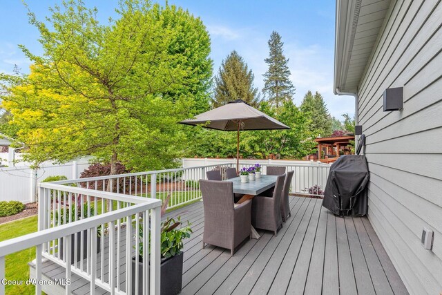 2946 E Point Hayden Dr, Hayden Lake, ID 83835 - wooden deck with outdoor dining area and a grill