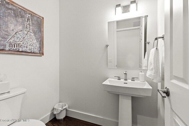 2946 E Point Hayden Dr, Hayden Lake, ID 83835 - bathroom featuring toilet, baseboards, wood finished floors, and a sink