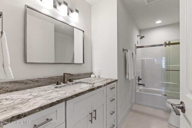 2946 E Point Hayden Dr, Hayden Lake, ID 83835 - bathroom featuring vanity, toilet, combined bath / shower with glass door, baseboards, and tile patterned floors