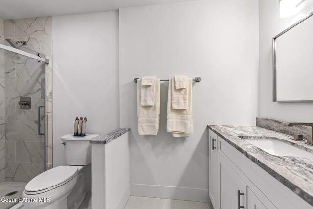 2946 E Point Hayden Dr, Hayden Lake, ID 83835 - full bathroom featuring vanity, toilet, a stall shower, and baseboards