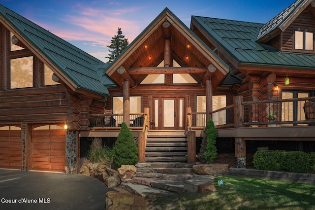 17442 S Painted Rose Rd, Worley, ID 83876 - view of exterior entry featuring log siding, metal roof, and a standing seam roof