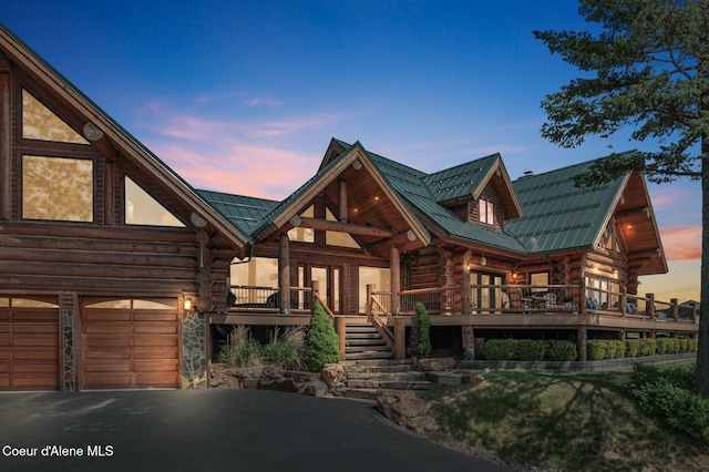 17442 S Painted Rose Rd, Worley, ID 83876 - log cabin with log siding, metal roof, asphalt driveway, a garage, and stairway