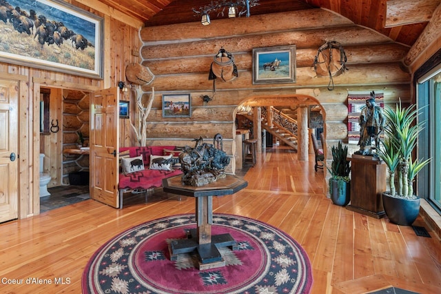 17442 S Painted Rose Rd, Worley, ID 83876 - interior space with log walls, hardwood / wood-style floors, wooden ceiling, and stairway