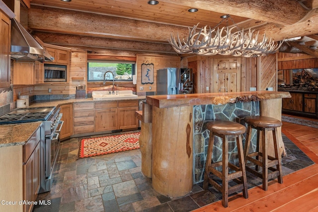 17442 S Painted Rose Rd, Worley, ID 83876 - kitchen with a sink, stainless steel appliances, wall chimney range hood, wooden ceiling, and a kitchen island