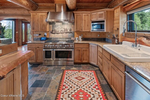 17442 S Painted Rose Rd, Worley, ID 83876 - kitchen featuring wall chimney exhaust hood, stainless steel appliances, a sink, stone tile flooring, and wooden ceiling with exposed beams