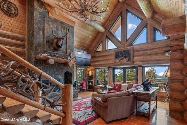 17442 S Painted Rose Rd, Worley, ID 83876 - living room featuring high vaulted ceiling, hardwood / wood-style floors, log walls, wood ceiling with exposed beams, and a stone fireplace