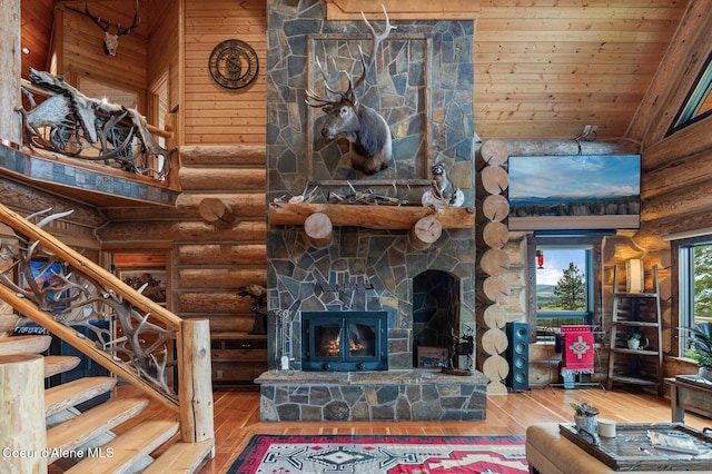 17442 S Painted Rose Rd, Worley, ID 83876 - living room with rustic walls, wood-type flooring, a fireplace, high vaulted ceiling, and stairway