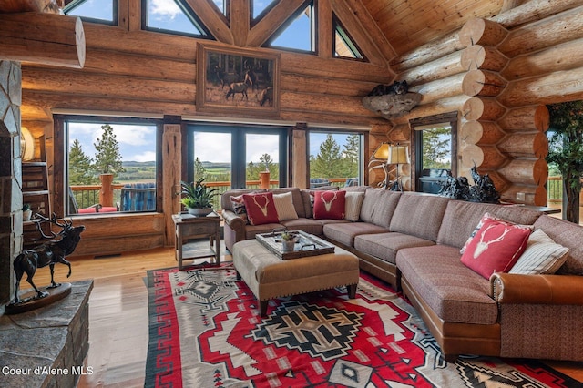 17442 S Painted Rose Rd, Worley, ID 83876 - living room with high vaulted ceiling, log walls, and hardwood / wood-style floors