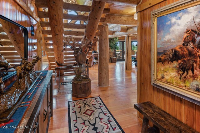 17442 S Painted Rose Rd, Worley, ID 83876 - corridor with log walls, beamed ceiling, light wood-style flooring, ornate columns, and stairs