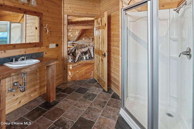 17442 S Painted Rose Rd, Worley, ID 83876 - bathroom featuring wooden walls, a shower stall, a sink, and stone finish floors