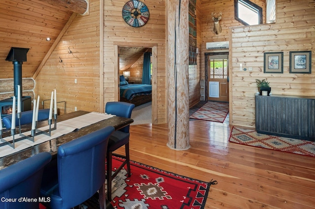 17442 S Painted Rose Rd, Worley, ID 83876 - home office featuring wood walls, hardwood / wood-style floors, a wood stove, high vaulted ceiling, and wooden ceiling with exposed beams