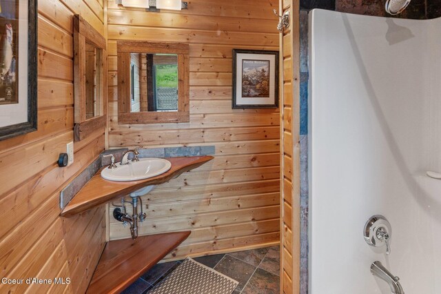 17442 S Painted Rose Rd, Worley, ID 83876 - full bathroom featuring wood walls, a sink, stone finish flooring, and shower / bath combination