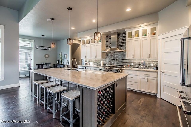 4732 W Mill River Ct, Coeur Dalene, ID 83814 - kitchen with wall chimney exhaust hood, a sink, stove, dark wood-style floors, and recessed lighting