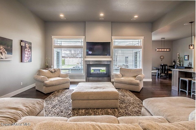 4732 W Mill River Ct, Coeur Dalene, ID 83814 - living room featuring baseboards, recessed lighting, a multi sided fireplace, and dark wood-style floors