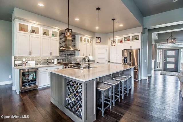4732 W Mill River Ct, Coeur Dalene, ID 83814 - kitchen with wall chimney exhaust hood, beverage cooler, high quality fridge, baseboards, and a sink