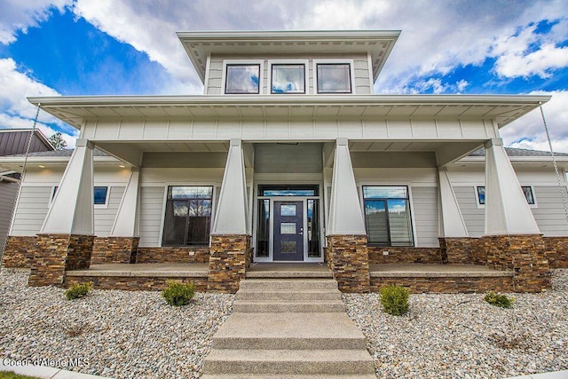 4732 W Mill River Ct, Coeur Dalene, ID 83814 - doorway to property with stone siding and covered porch