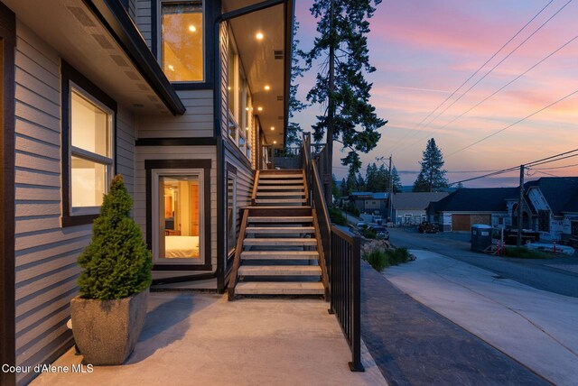 2406 S Silver Beach Rd, Coeur Dalene, ID 83814 - exterior entry at dusk featuring a residential view