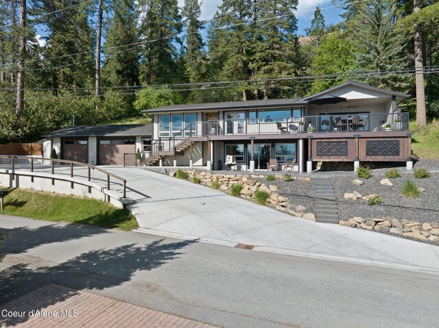 2406 S Silver Beach Rd, Coeur Dalene, ID 83814 - view of front facade with stairway, concrete driveway, and a porch