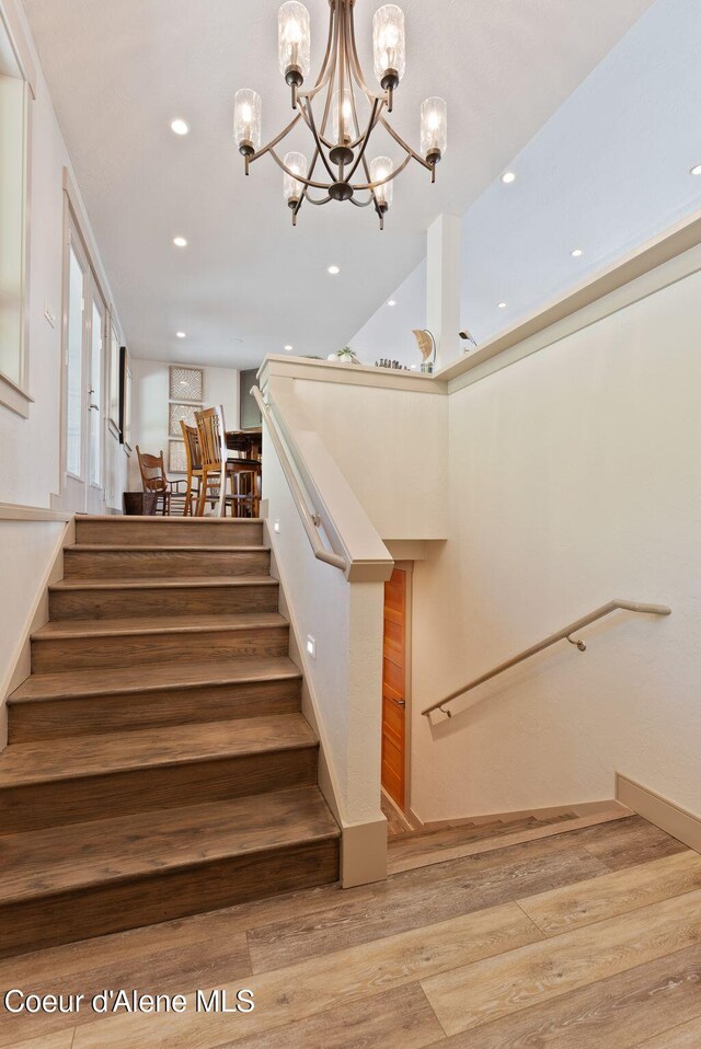 2406 S Silver Beach Rd, Coeur Dalene, ID 83814 - stairway with wood finished floors, a chandelier, and recessed lighting