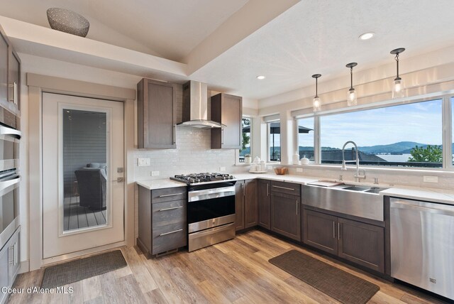 2406 S Silver Beach Rd, Coeur Dalene, ID 83814 - kitchen featuring stainless steel appliances, wall chimney exhaust hood, a sink, plenty of natural light, and recessed lighting