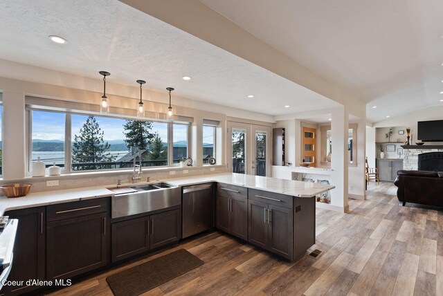 2406 S Silver Beach Rd, Coeur Dalene, ID 83814 - kitchen with dishwasher, a sink, recessed lighting, light wood-style flooring, and a peninsula