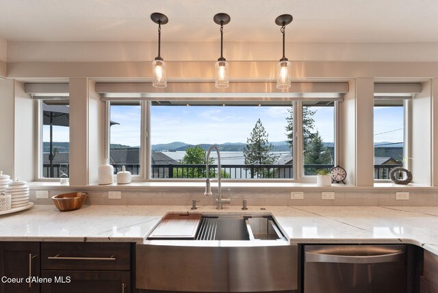 2406 S Silver Beach Rd, Coeur Dalene, ID 83814 - kitchen with dishwasher, a sink, light stone countertops, pendant lighting, and a mountain view