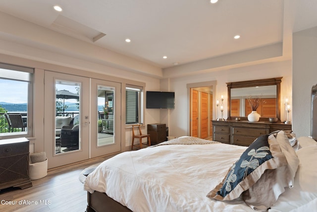 2406 S Silver Beach Rd, Coeur Dalene, ID 83814 - bedroom featuring access to outside, wood finished floors, french doors, recessed lighting, and attic access