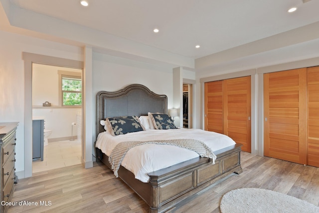 2406 S Silver Beach Rd, Coeur Dalene, ID 83814 - bedroom featuring recessed lighting, light wood-type flooring, ensuite bathroom, baseboards, and two closets