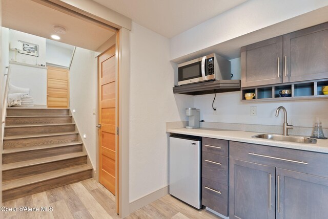 2406 S Silver Beach Rd, Coeur Dalene, ID 83814 - kitchen with a sink, fridge, light wood-type flooring, open shelves, and stainless steel microwave