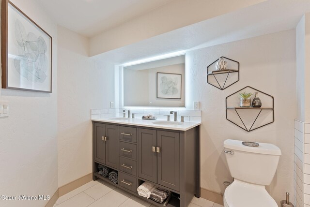 2406 S Silver Beach Rd, Coeur Dalene, ID 83814 - full bath featuring double vanity, toilet, tile patterned flooring, and baseboards