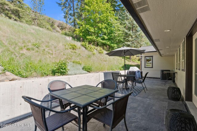 2406 S Silver Beach Rd, Coeur Dalene, ID 83814 - view of patio featuring outdoor dining area and cooling unit