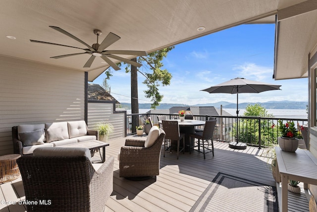 2406 S Silver Beach Rd, Coeur Dalene, ID 83814 - wooden deck with an outdoor hangout area, outdoor dining area, and ceiling fan