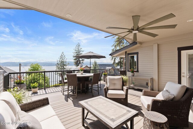 2406 S Silver Beach Rd, Coeur Dalene, ID 83814 - wooden deck featuring a water view, outdoor dining space, and outdoor lounge area